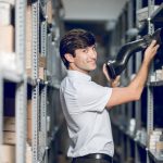 A man who helped organize the storage plan for your business, putting stuff on a shelf.