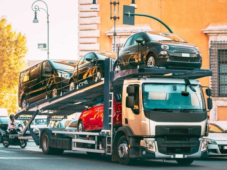 Cars behind a tow truck in the city for vehicule relocation in the Philippines