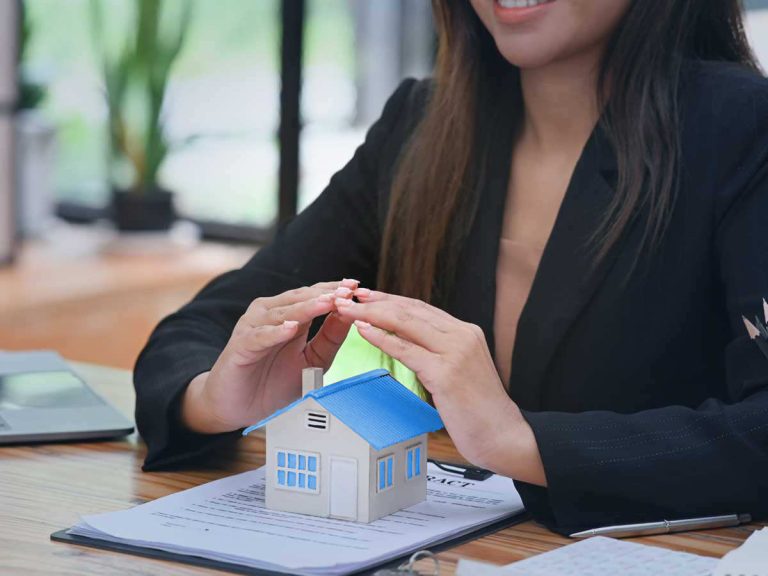 Asian agent showing a blue model house for home search services in vietnam