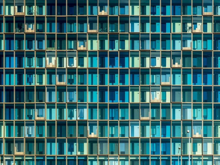 Face of blue glass building for temporary housing search in thailand