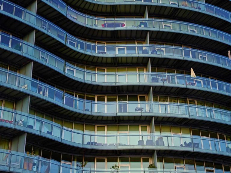 modern glass facade of curved apartment building for temporary housing search in vietnam
