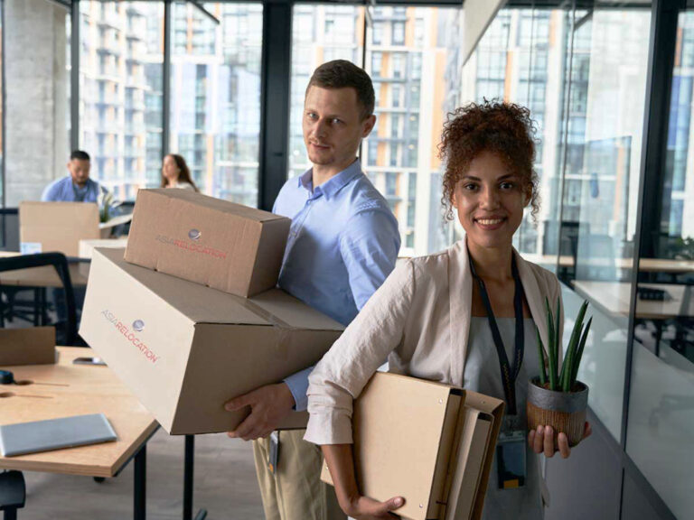 Staffs moving boxes with a smiling girl for office relocation services