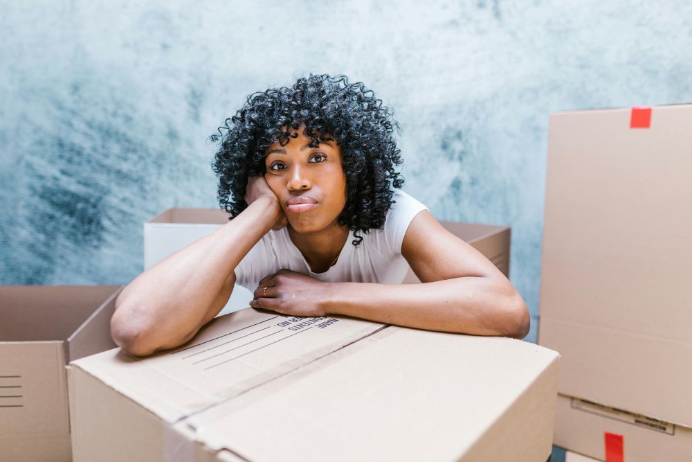 A woman resting her arms on boxes