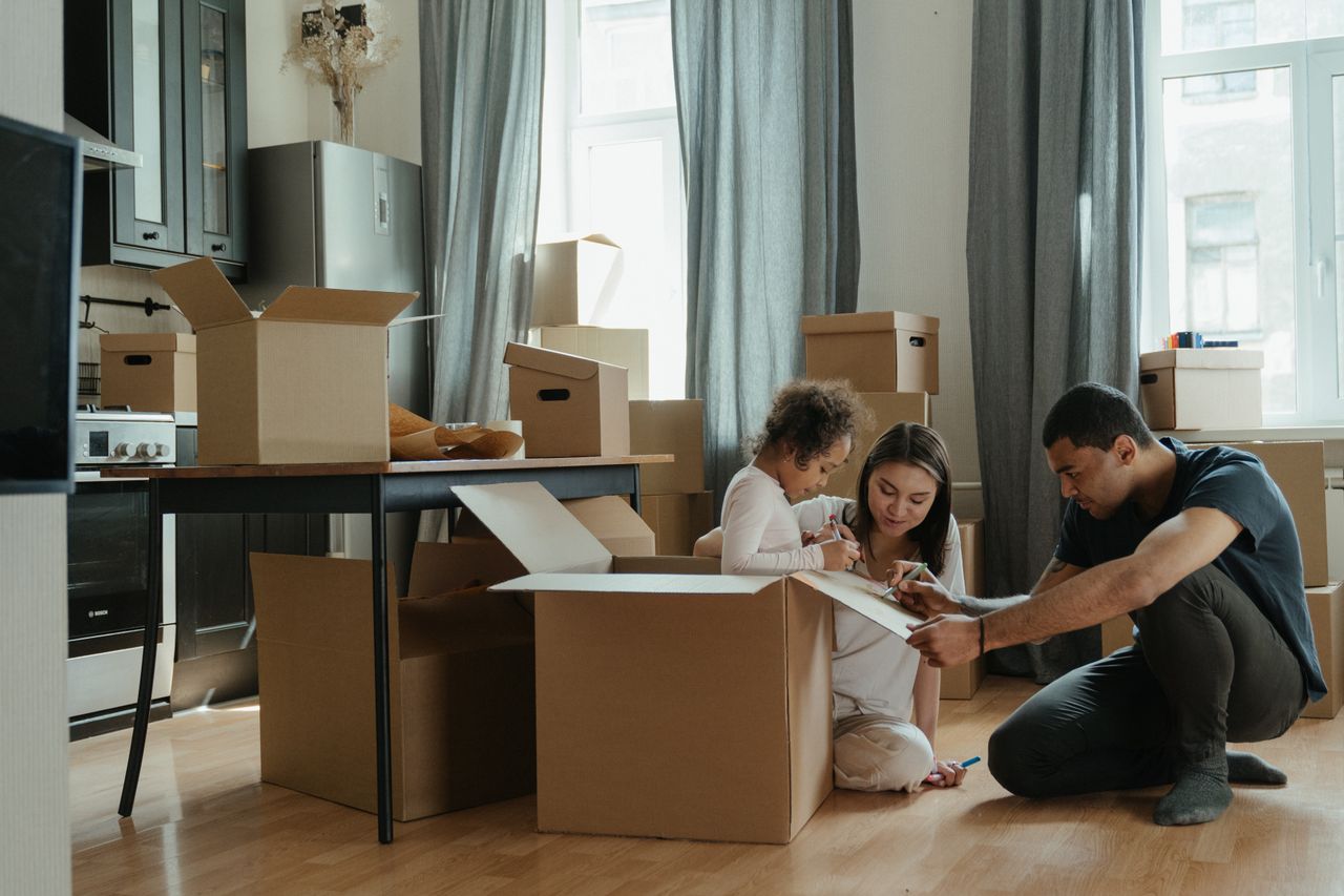 Family unpacking in a new home in the Philippines
